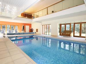 a swimming pool in a house with a large building at Abbots Wood in Netley
