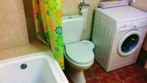 a bathroom with a toilet and a washing machine at Sweet Home in Volos