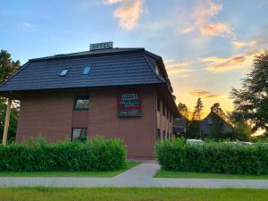 a red brick building with a sign on it at Hotel Borchers in Dörpen +35 photos