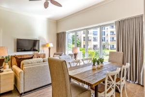 a living room with a table and a couch at Honua Kai - Hokulani 110 - 2 Bed 2 Bath Apartment in Honua Kai Resort in Lahaina