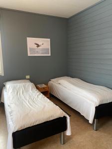 Postel nebo postele na pokoji v ubytování Skoghus