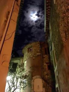an old building at night with the moon in the sky at Casa AZA in Roquebrune-Cap-Martin