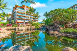 a pool in front of a hotel with a resort at Honua Kai - Hokulani 110 - 2 Bed 2 Bath Apartment in Honua Kai Resort in Lahaina