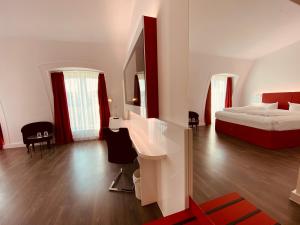 a bedroom with a bed and a desk in it at DORMERO Hotel Dresden City in Dresden