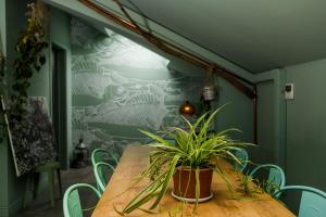 a dining room with a wooden table with plants on it at Bello!Lake Como Suites in Como