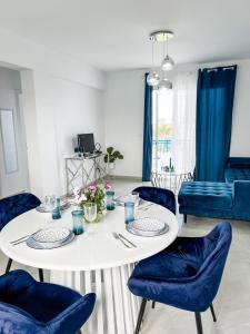 a living room with a white table and blue chairs at BLUE LATSI in Lachi