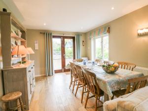 a kitchen and dining room with a table and chairs at Long Meadow in Heyshott