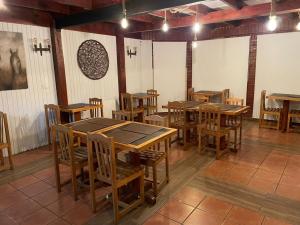 a dining room with wooden tables and chairs at HOTEL VOLKANICO in Curacautín