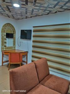 a living room with a couch and a table at Ameer apartment in Wadi Musa