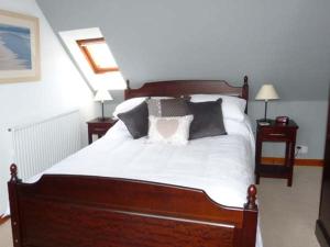 a bedroom with a large bed with black and white pillows at Seascape in Buckie