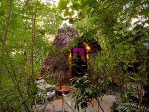 a tree house in the middle of a forest at Archery-Asia Nipa Huts Moalboal in Moalboal