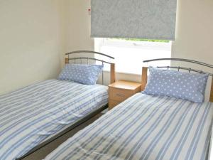 two beds sitting next to each other in a bedroom at Seascape in Lowestoft
