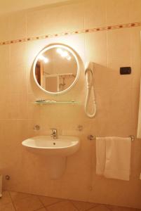 a bathroom with a sink and a mirror at Hotel La Maddalena in Quattro Castella
