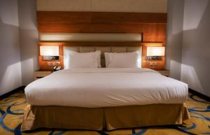 Un pat sau paturi într-o cameră la Sultanate Jazan