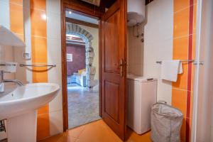 a bathroom with a sink and a toilet and a mirror at House Luce in Krapan +6 photos