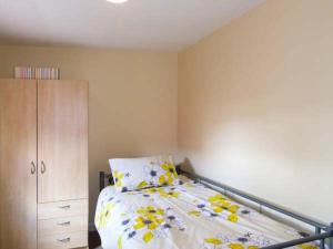 a bedroom with a bed and a dresser at Ferrys in Portsalon +4 photos