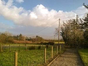 a field with a fence and a field with at Ferrys in Portsalon