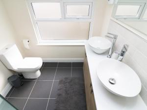 ein Badezimmer mit Waschbecken und Toilette in der Unterkunft Wysteria Cottage in Windermere + 15 Fotos