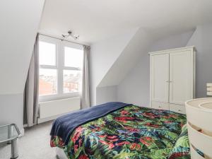 a bedroom with a bed and a window at Lighthouse View in Great Yarmouth