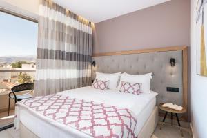 Postel nebo postele na pokoji v ubytování M City Hotel