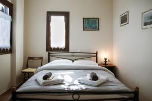 1 dormitorio con 1 cama con toallas en Feels like home apartment in Zagora en Zagora