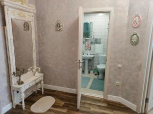 クルスクにあるGarmoniya Apartmentのバスルーム(シャワー、トイレ、シンク付)