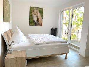 Cama ou camas em um quarto em Ferienwohnung Freyja Hafenspitze Eckernförde