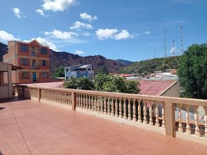 a balcony with a view of a city and mountains at Hostal Aramayo in Tupiza