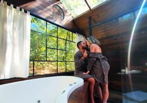 Ein Mann und eine Frau sitzen in einer Badewanne in der Unterkunft Viva Brotas in Brotas