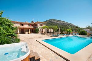 a house with a swimming pool and a house at Villa Cal Apostol in Pollença