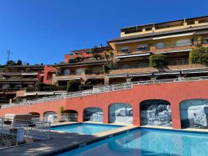 a swimming pool in front of a building at Portofino Est Residence in Rapallo