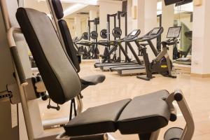 a gym with a row of tread machines at HOTEL BARONE DI MARE in Torre dell'Orso