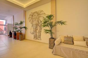 a living room with a couch and a painting on the wall at Elita Apartment in Los Llanos de Aridane