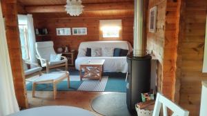 a bedroom with a bed and a wood stove at Das blaue Häuschen in Westerholz