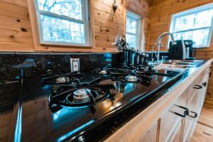 a kitchen with a stove top in a wooden kitchen at Sunset Chalet in Belgrade