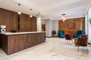 a lobby with a reception desk and chairs at Old Riga Plaza Hotel in Riga