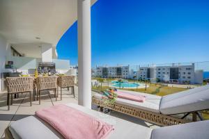 a balcony with a view of a pool and buildings at HigueronRentals Casa Kiki in Málaga