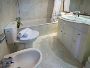 łazienka z umywalką, toaletą i wanną w obiekcie Apartamentos Rubino (13º-B) w mieście Calpe