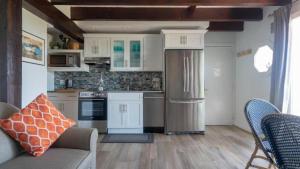 a kitchen with a refrigerator and a couch in a room at Beachcomber Resort at Montauk in Montauk