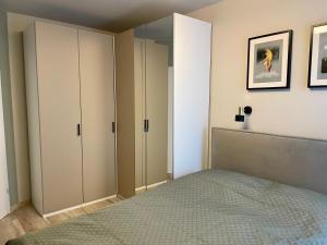 a bedroom with a bed and a mirror at Uroczy Apartament 38 m2 Tychy, Śląskie Ogrody in Tychy +5 photos