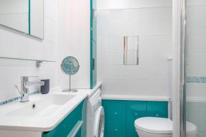 a bathroom with a white sink and a toilet at Face Mer appartement pour 4 personnes in Pornic +11 photos