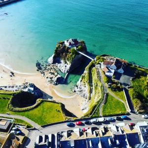 an aerial view of a beach with houses and the ocean at Lazy Waves Boutique B&B in Newquay