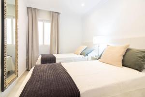 Posteľ alebo postele v izbe v ubytovaní Atarazanas FreshApartments