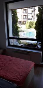 A bed or beds in a room at studio by the Pool in Aspen Heights Bansko