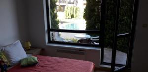 A bed or beds in a room at studio by the Pool in Aspen Heights Bansko