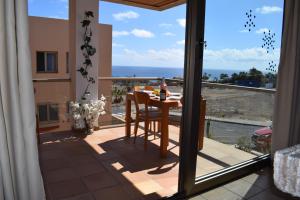 a balcony with a table and a view of the ocean at Suite del Mar Playa Esquinzo 1 Jandia Fuerteventura in Playa Jandia