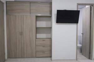 a room with a tv and a closet at OMA HOTEL LA GUAJIRA in Camarones