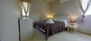 a bedroom with a bed and a table with a lamp at KatlantiK Ca Madeira Deluxe in Sal Rei