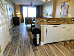 a kitchen with a counter and a trash can at 3 BR Direct Oceanfront Condo Wyndham Ocean Walk Resort - Daytona Funland 1023 in Daytona Beach