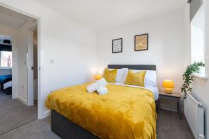 林肯的住宿－The Holt - 2 Double Bedrooms with Parking，一间卧室配有一张带黄色床单的大床
